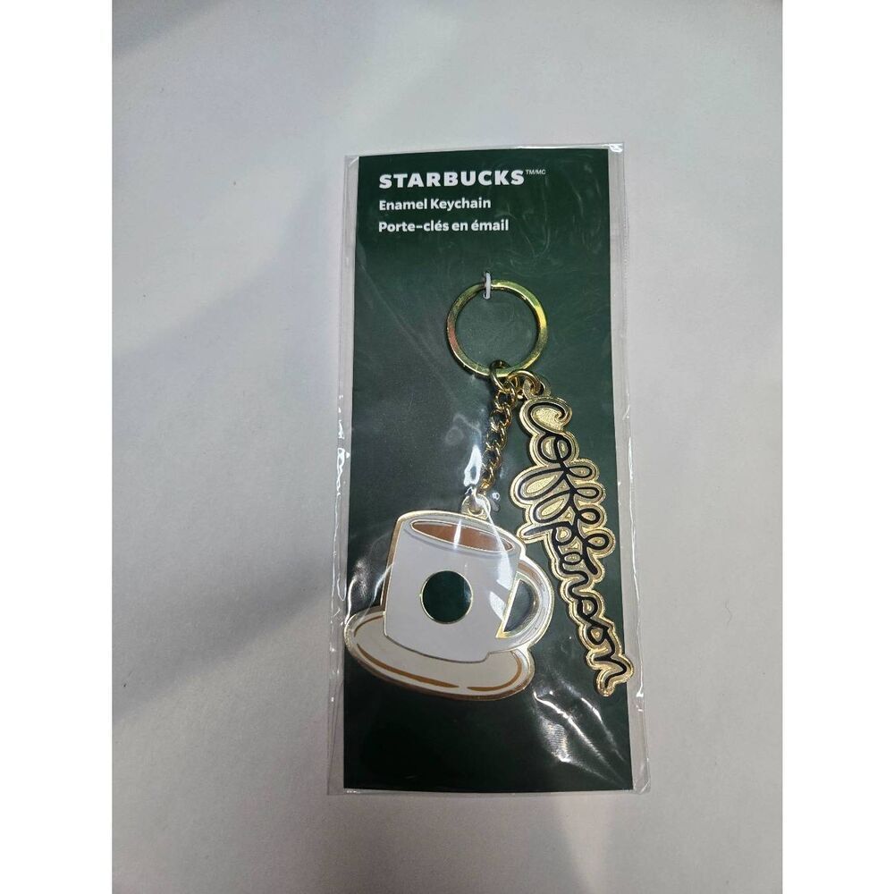This is a Starbucks enamel keychain set featuring a coffee cup and a decorative